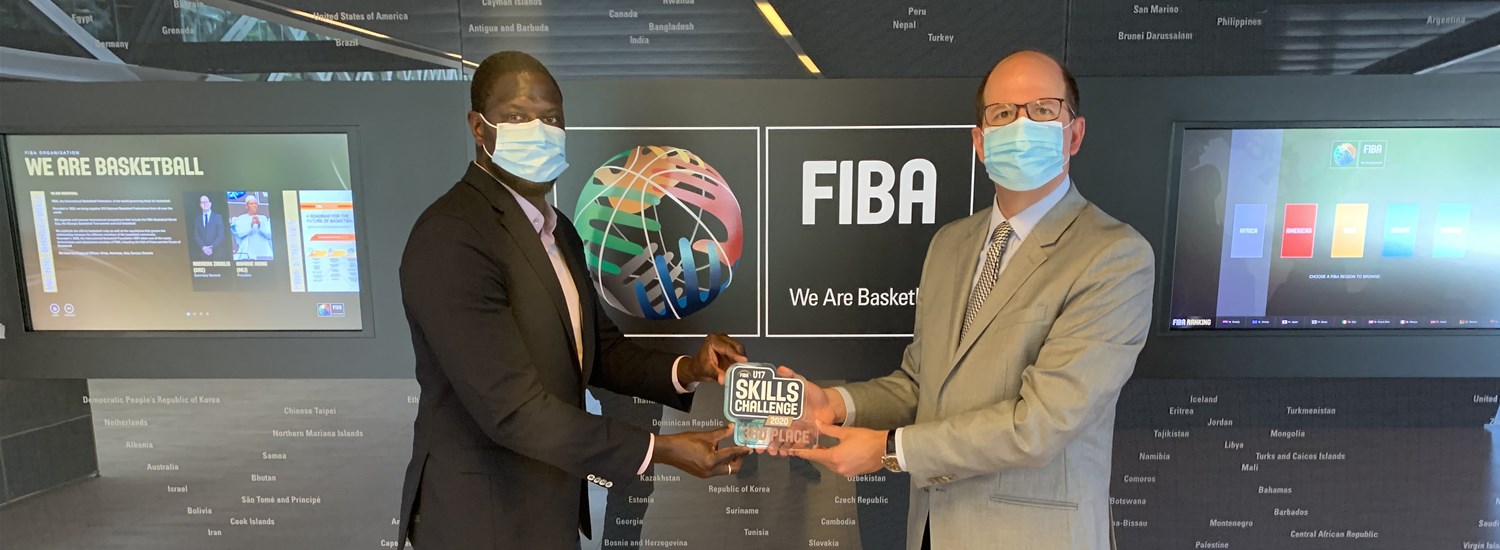 Secretary General of Guinea Basketball Federation Oumar CAMARA SAMPIL accepts FIBA U17 Skills Challenge Third Place Trophy from FIBA Secretary General Andreas Zagklis.