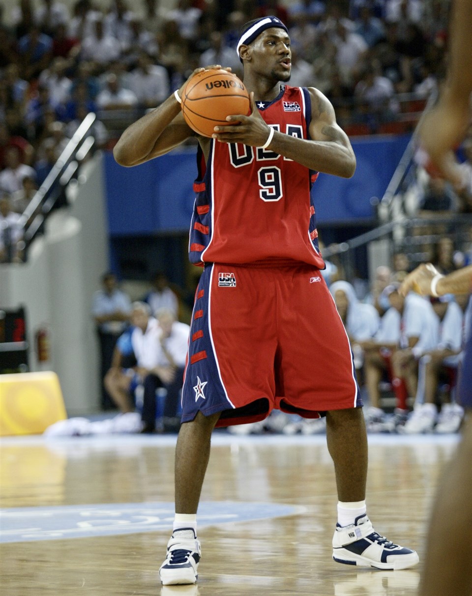 Aug 15, 2004; Athens, GREECE; Puerto Rico's Carlos Arroyo (R) pumps his  jersey toward fans in the stands while the U.S.'s Allen Iverson walks off  the court after Puerto Rico beat the